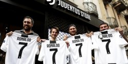 Para pendukung Juventus berpose dengan seragam nomor punggung 7 bertuliskan nama Cristiano Ronaldo di depan gerai Juventus Store di Turin, 10 Juli 2018.