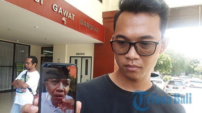 Gede Ari Suardika menunjukkan kondisi ayahnya, Perbekel Desa Jinengdalem Ketut Ardika yang mengalami keracunan usai menenggak minuman kemasan, Selasa (11/12/2018).