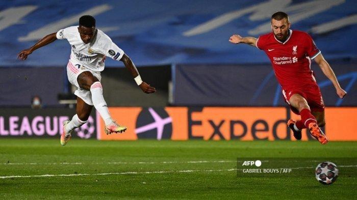 Pemain depan Real Madrid Brazil Vinicius Junior (kiri) mencetak gol melewati bek Liverpool asal Belanda Virgil van Dijk selama pertandingan sepak bola perempat final leg pertama Liga Champions UEFA antara Real Madrid dan Liverpool di stadion Alfredo di Stefano di Valdebebas di pinggiran Madrid pada 6 April 2021.