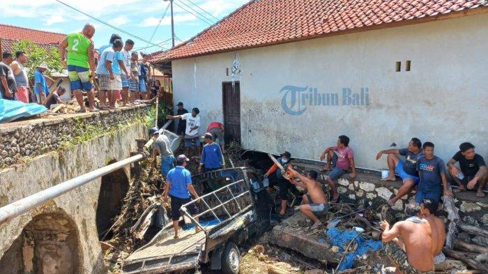 Warga bergotong-royong evakuasi mobil yang menyangkut di aliran Sungai Karangsari, Desa Suana, Nusa Penida, Bali akibat terbawa arus banjir bandang, Senin 13 Desember 2021 - UPDATE: Sebanyak 12 Kendaraan Hanyut Terbawa Banjir Bandang di Nusa Penida Bali