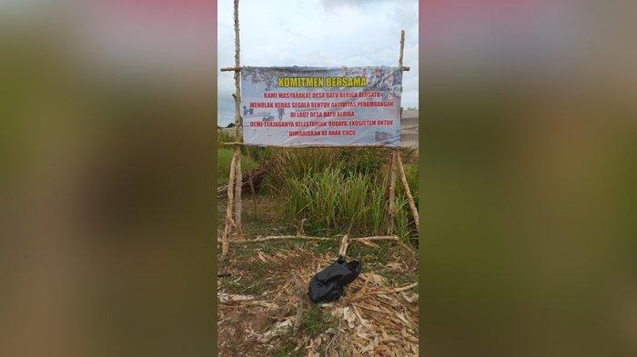 Baleho penolakan aktivitas tambang yang dipasangkan di laut Desa Batu Beriga