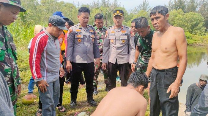 Seorang warga memberikan pertolongan kepada JC korban tenggelam di eks kolong TI di Desa Kebintik, Kecamatan Pangkalan Batu di dampingi beberapa anggota TNI/Polri, Minggu (3/4/2022).