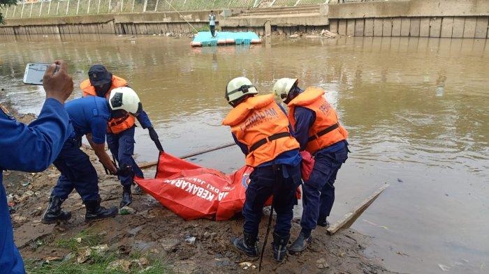 Personel Damkar Jakarta Timur saat proses evakuasi jasad AF (27) di aliran Kali Ciliwung, Kramat Jati, Jumat (4/2/2022)