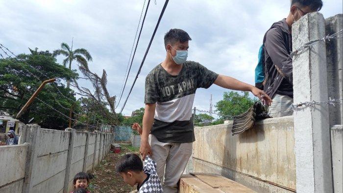 Potret warga Jalan Akasia Nomor 1 RT 04/03, Tajur, Kecamatan Ciledug, Kota Tangerang harus memanjat tembok beton setinggi dua meter untuk keluar masuk rumahnya di kawasan Tajur, Kota Tangerang, Senin (15/3/2021).