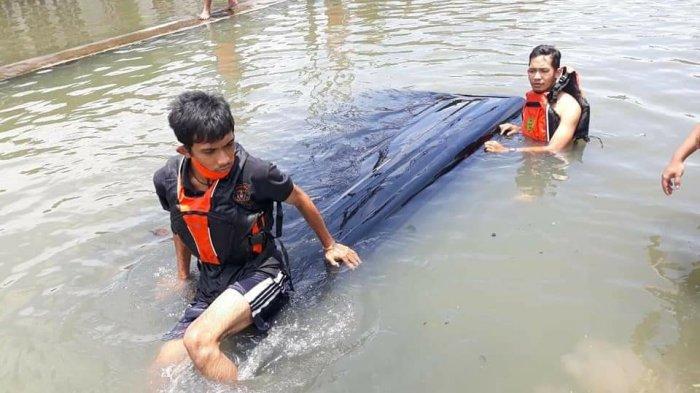 Mobil Gran Max warna hitam asal Tuban kecebur sungai Gebanganom lantaran sopir tak waspada saat jalan direndam banjir, di Kota Semarang, Jumat (26/2/2021).