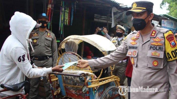 Kapolres Sumenep, AKBP Darman saat membagikan 500 masker bagi warga dan pedagang di Pasar Anom Baru Sumenep, Senin (1/2/2021).