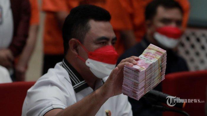 Direktur Tindak Pidana Ekonomi Khusus (Dirtipideksus) Bareskrim Polri Brigjen Whisnu Hermawan menunjukkan barang bukti mata uang dolar dan rupiah palsu saat rilis pengungkapan kejahatan mata uang palsu di Bareskrim Mabes Polri, Jakarta, Selasa (1/3/2022).
