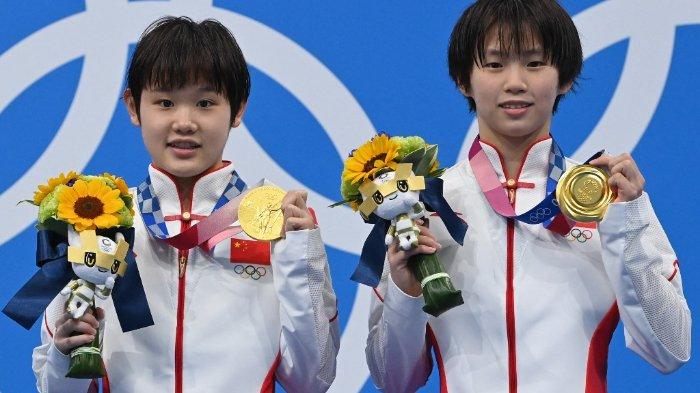 Peraih medali emas China Zhang Jiaqi dan Chen Yuxi berpose di podium setelah acara final lompat platform 10m putri selama Olimpiade Tokyo 2020.