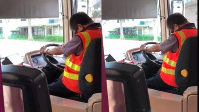 Sopir menundukkan kepala saat mengemudi