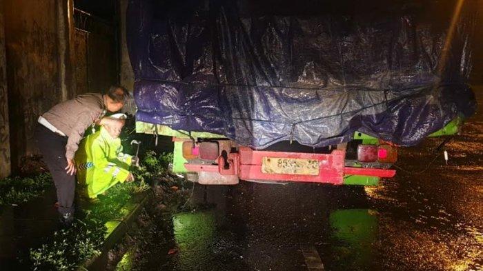 Petugas melakukan olah TKP di lokasi kejadian kecelakaan pengendara motor tabrak truk yang merenggut korban jiwa di jalan raya Nasional, Desa Jatipasar, Trowulan, Kabupaten Mojokerto, Jumat (21/10/2022).