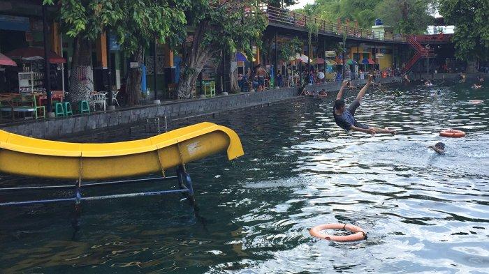Wisatawan bermain papan seluncur di Umbul Ponggok.