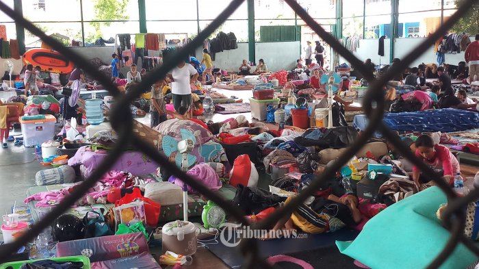 PADAT OLEH PENGUNGSI - Pengungsi memadati lokasi pengungsian di GOR Perum Total.Persada, Periuk, Kota Tangerang, Senin (22/2/2021). Banjir yang masih merendam rumah mereka, membuat warga terpaksa harus mengungsi, meski dibayangi kekhawatiran terkena paparan Covid-19 di masa pandemi seperti ini. WARTA KOTA/NUR ICHSAN