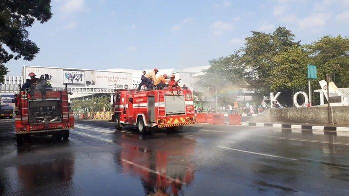 Petugas melakukan penyemprotan cairan disinfektan di area car free day (CFD) Jalan Ahmad Yani, Kecamatan Bekasi Selatan, Kota Bekasi, saat pandemi virus corona.