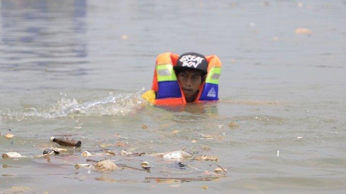 petugas DLH Kota Tangerang membersihkan sampah di Sungai Cisadane