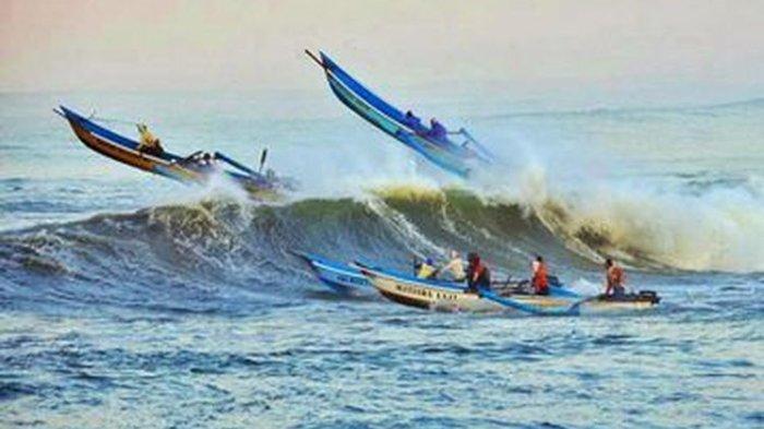 Beberapa perahu nelayan menerjang gelombang tinggi di perairan Teluk Penyu, Cilacap, Jawa Tengah.
